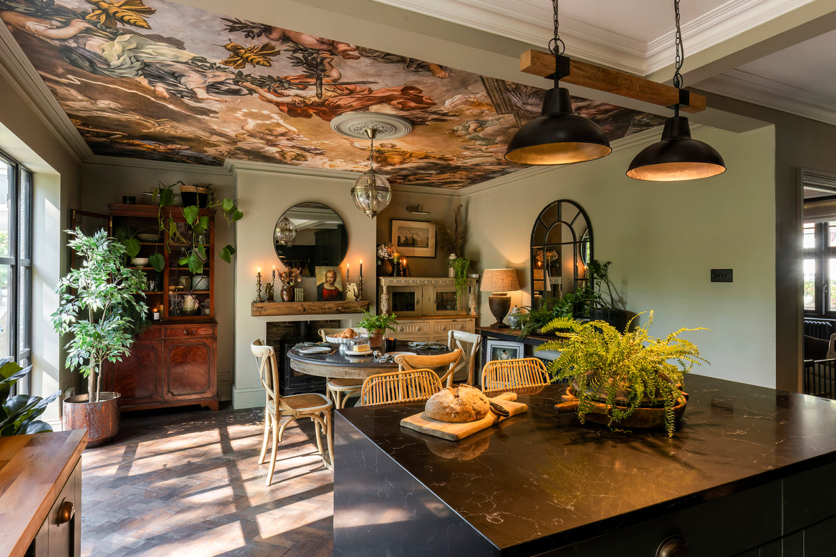 An intimate dining room with dark, dramatic styling by Delve Interiors