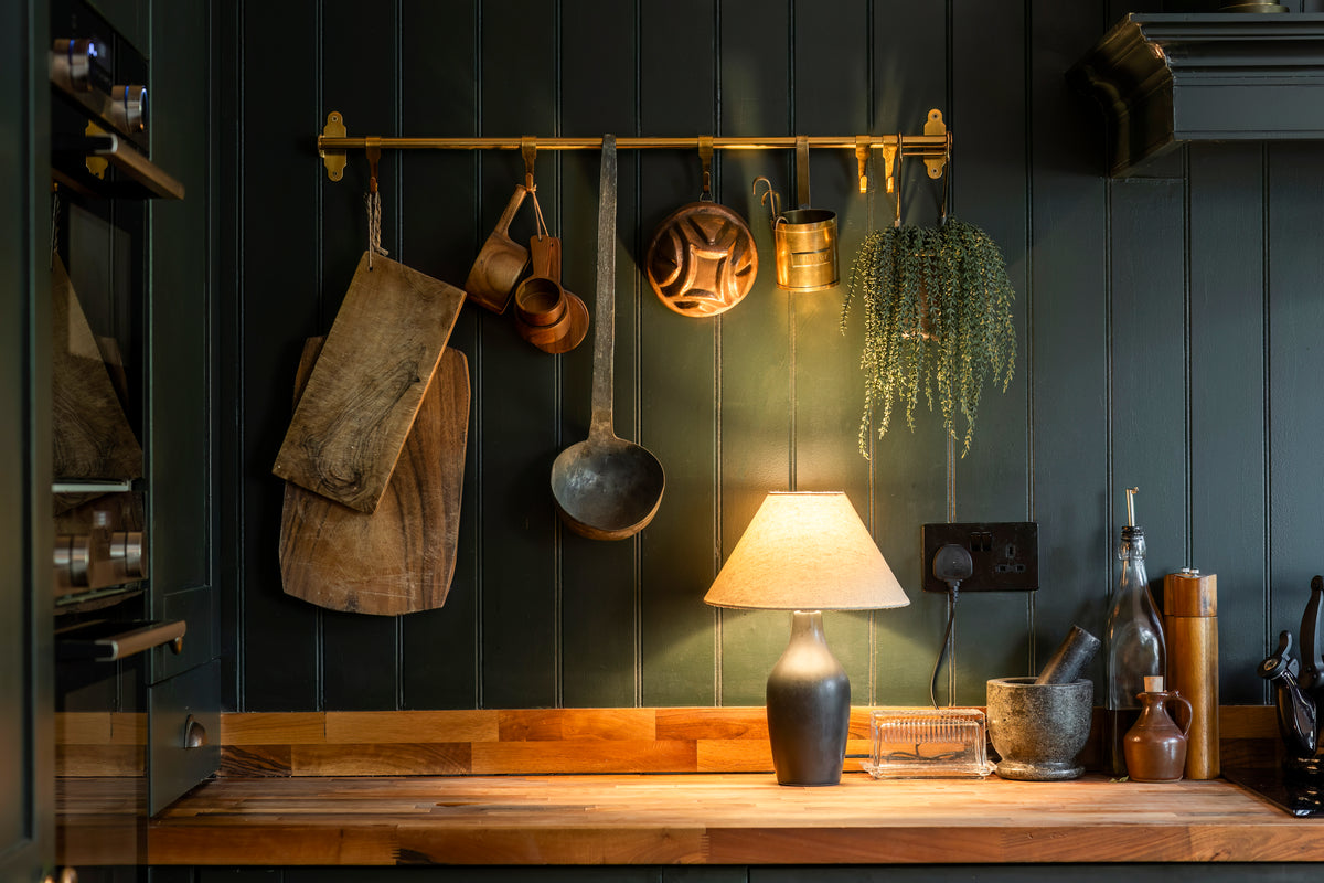 Kitchen details showing warm wood and metal finishes by Delve Interiors