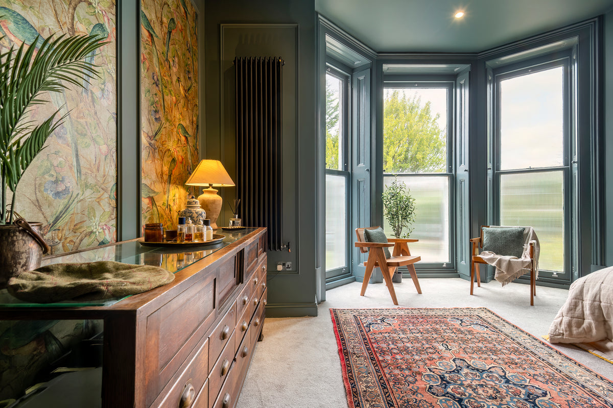A richly styled bedroom with deep tones designed by Delve Interiors