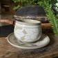 White and beige tea cup and saucer