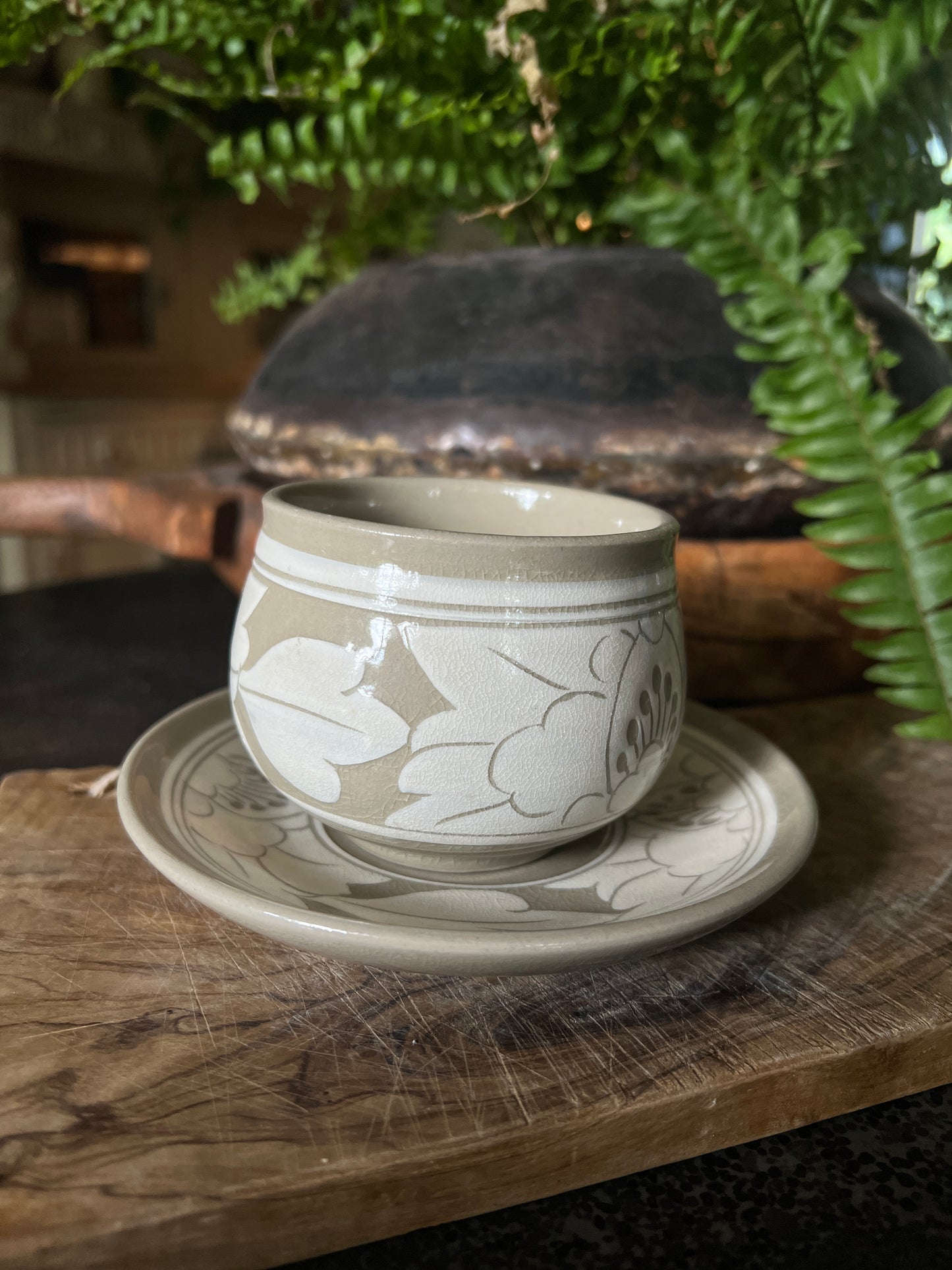 White and beige tea cup and saucer