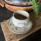White and beige tea cup and saucer