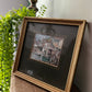 Framed painting of a seaside town