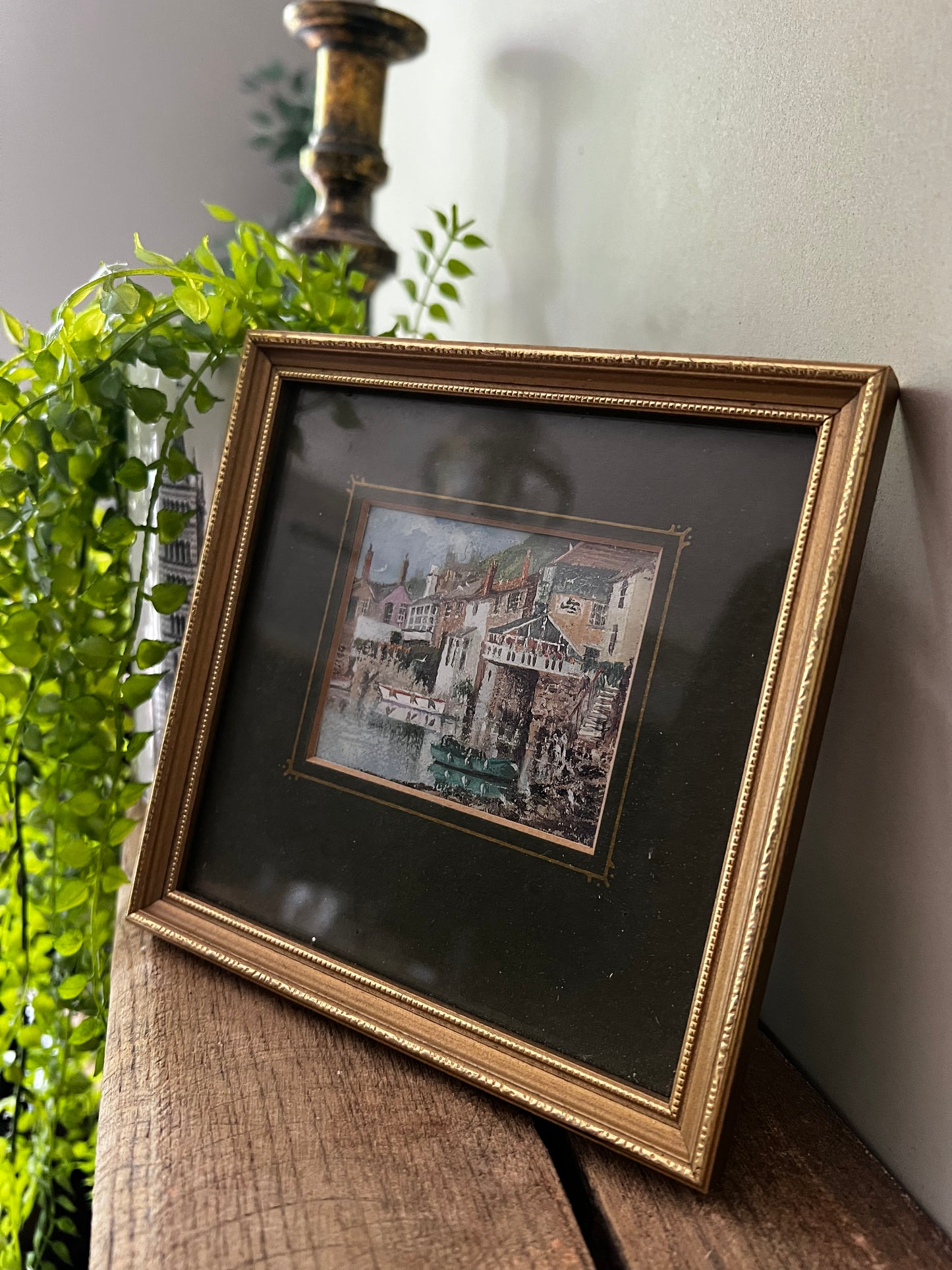 Framed painting of a seaside town