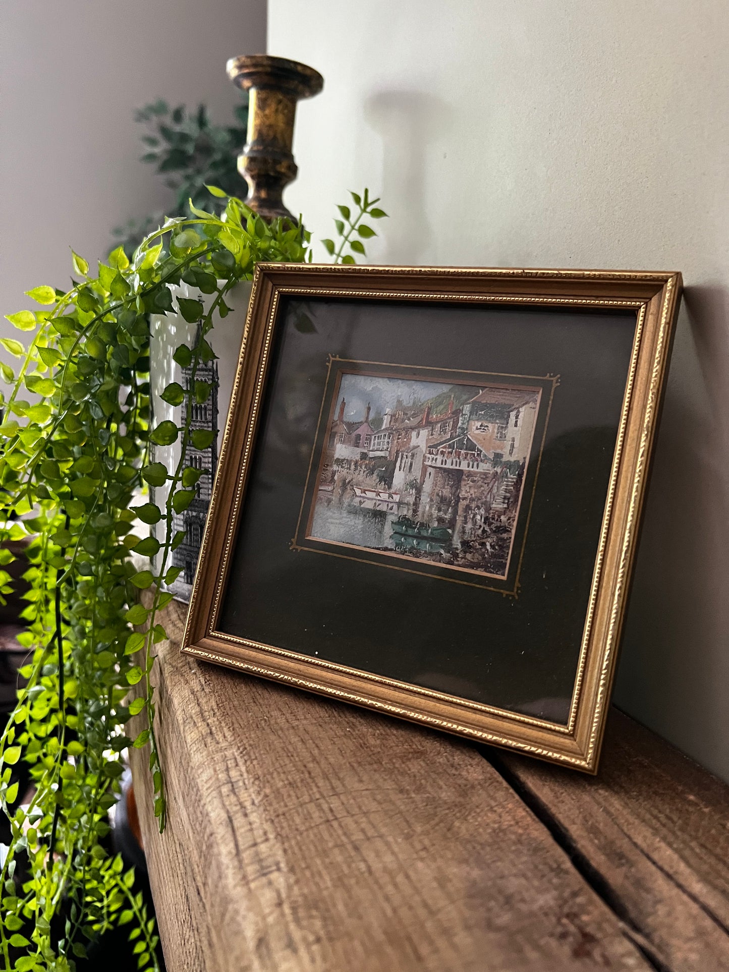 Framed painting of a seaside town